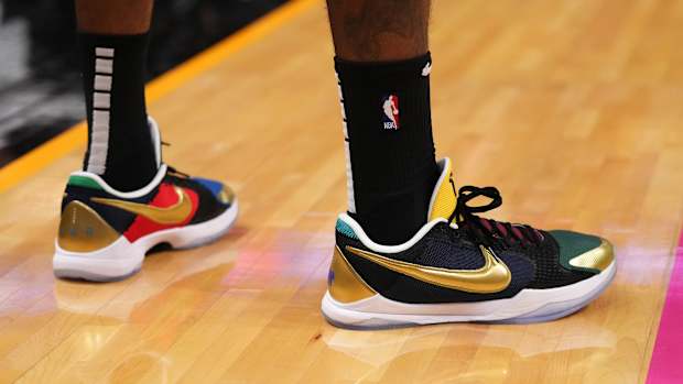 View of black and gold Nike Kobe shoes.